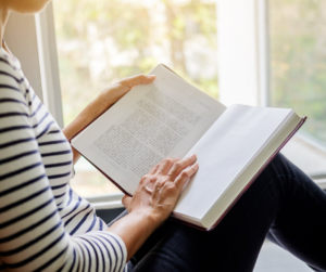 A woman reading as a top weekend activity to improve productivity