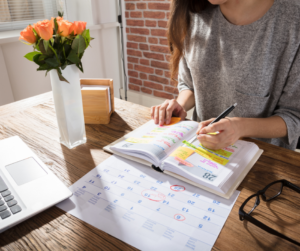 A woman creating a schedule in her diary