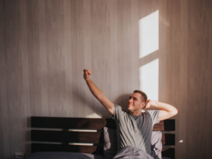A man stretching in bed