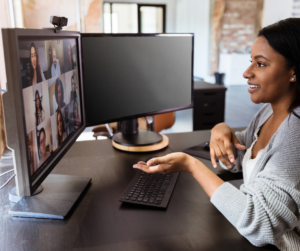 A woman sitting at her desk having a virtual meeting