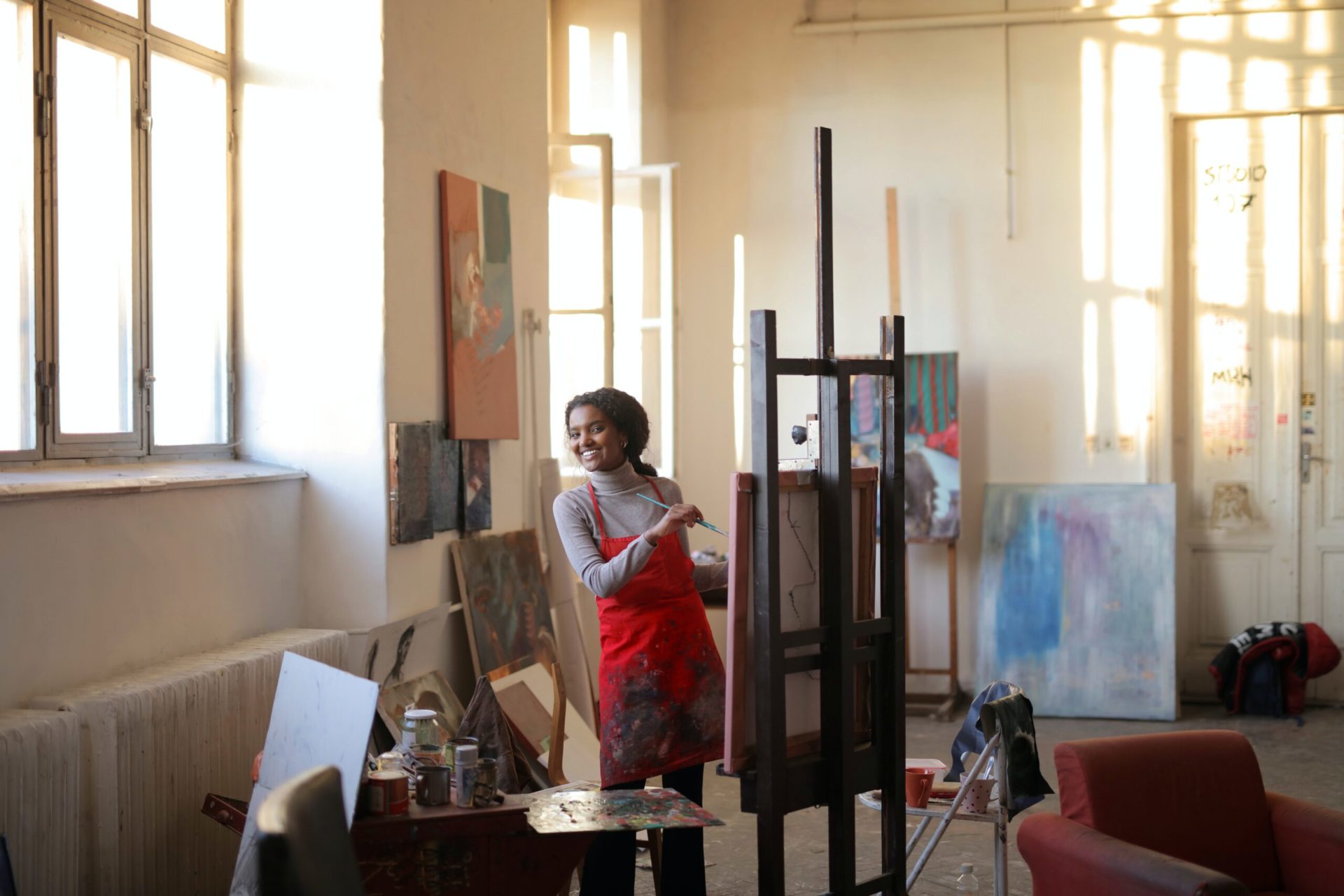 A woman painting in a studio