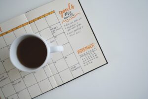 A coffee mug on a diary used to plan a day